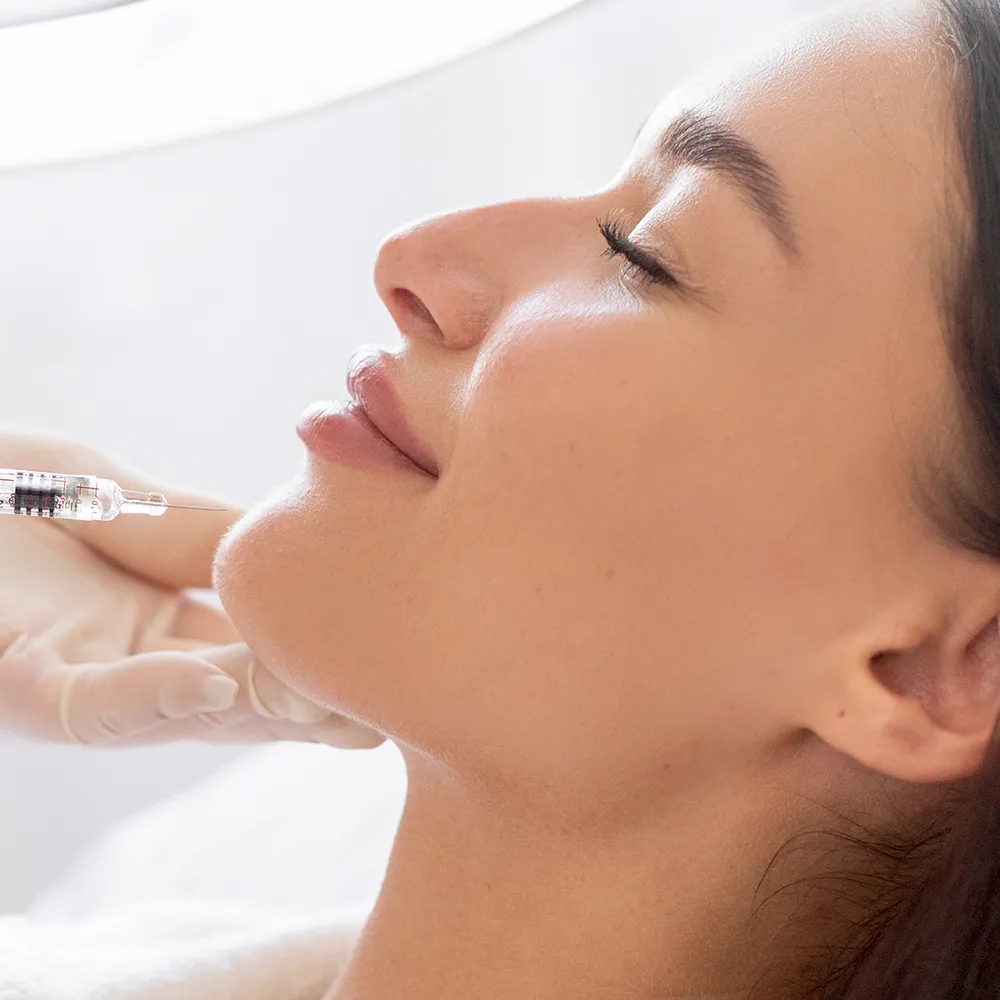 A woman receiving Botox and Juvederm injections.